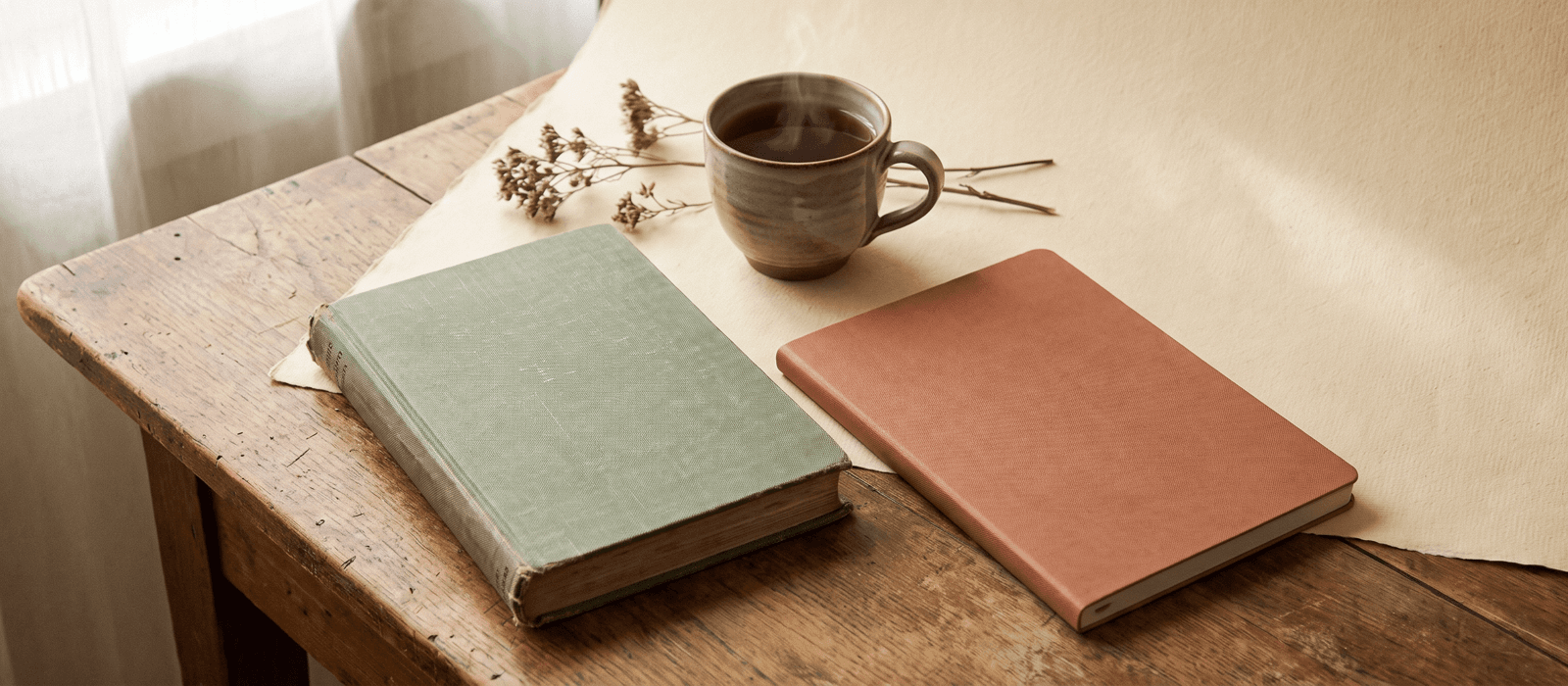 Two different notebooks side by side sharing one cup of tea